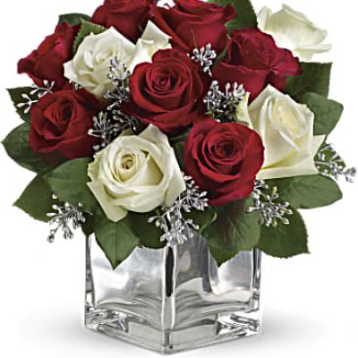 Give Christmas a charmingly contemporary spin with lush red and white roses in a dazzling mirrored silver cube. With a merrily moderate price tag, it makes the perfect gift for all the people on your list – naughty or nice.

The impressive bouquet includes red roses and white roses accented with assorted greenery.
<ul>
 	<li>Our florists hand-design each arrangement, so colors, varieties and containers may vary due to local availability</li>
</ul>