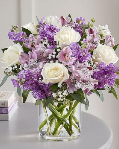Lovely memories are made with thoughtful gifts for the ones we care about. Our charming bouquet is loosely gathered with a medley of lavender & white blooms. Hand-designed inside a clear cylinder vase with cascading greenery all around, it’s a wonderful way to express the sentiments you have inside your heart.
<ul>
 	<li>Our florists hand-design each arrangement, so colors, varieties and containers may vary due to local availability</li>
</ul>