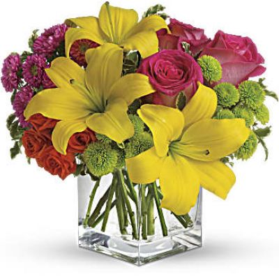 Splash into spring! Sun-bright yellow, hot pink and orange blooms add up to a sensational and oh-so-stylish spring & summer floral arrangement for any occasion.
Hot pink and orange roses are mixed with yellow asiatic lilies, hot pink matsumoto asters and lime green button spray chrysanthemums in a clear glass cube vase.
<ul>
 	<li>Our florists hand-design each arrangement, so colors, varieties and containers may vary due to local availability</li>
</ul>