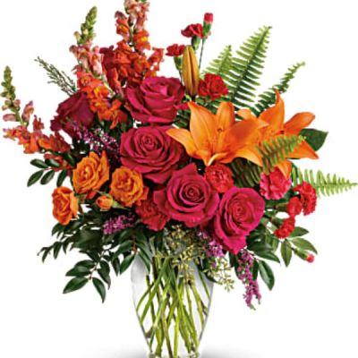 <div class="m-pdp-tabs-description">
<div id="mark-2" class="m-pdp-tabs-marketing-description">The bright stuff for punching up anyone's mood! Bring happiness to any day with this bold, sunset-inspired blend of hot pink roses and orange lilies in a classic glass vase!</div>
</div>
Hot pink roses, orange spray roses, orange asiatic lilies, hot pink carnations, red miniature carnations, orange snapdragons, and pink heather are accented with sword fern, huckleberry, seeded eucalyptus, and lemon leaf. Delivered in a clear glass vase.
<ul>
 	<li>Our florists hand-design each arrangement, so colors, varieties and containers may vary due to local availability</li>
</ul>