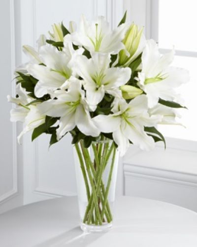 The FTD® Light In Your Honor™ Bouquet is a beautifully bright arrangement bursting with elegant fragrance to convey your deepest sympathies for the loss of their loved one. A stunning bouquet of gorgeous Oriental lilies are accented with lush greens and seated in a clear glass vase to create a bouquet that is serenely sophisticated, offering comfort and peace in their time of need.
<ul>
 	<li>Our florists hand-design each arrangement, so colors, varieties and containers may vary due to local availability</li>
</ul>
