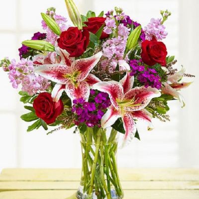 Enjoy this exquisite combination of red and purple bloom guaranteed to make your recipient equally dazzled with the unparalleled beauty of this arrangement. Whether it's for a special occasion or just because, it's a gift that you'll be glad you sent.
<ul>
 	<li>Our florists hand-design each arrangement, so colors, varieties and containers may vary due to local availability</li>
</ul>