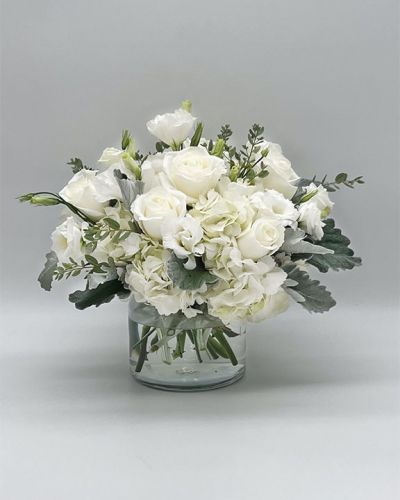 If you're looking for the perfect gift in a dazzling array of white flowers, then look no further as this arrangement is guaranteed to turn heads and make your recipient smile.
<ul>
 	<li>Our florists hand-design each arrangement, so colors, varieties and container may vary due to local availability</li>
</ul>