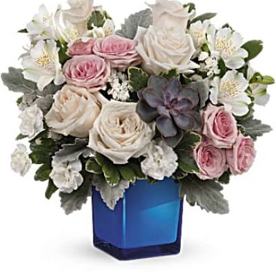 <div id="mark-3" class="m-pdp-tabs-marketing-description">Soft as a whisper, this enchanting bouquet of cream and pink roses looks oh-so-lovely in a colored or clear glass cube that later becomes a comely candleholder.</div>
&nbsp;
<div id="desc-3">Crème roses, pink spray roses, white alstroemeria and miniature white carnations are arranged with variegated pittosporum, dusy miller, white sinuata statice and a large, potted green echeveria succulent.
<ul>
 	<li>Our florists hand-design each arrangement, so colors, varieties and containers may vary due to local availability</li>
</ul>
</div>