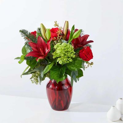 This stunning arrangement of reds and greens will be the center of attention.  Delivered in a colored or clear glass vase.
<ul>
 	<li>Our florists hand-design each arrangement, so colors, varieties and container may vary due to local availability</li>
</ul>
&nbsp;