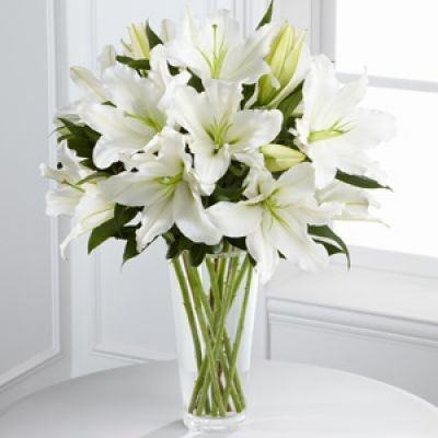 The FTD® Light In Your Honor™ Bouquet is a beautifully bright arrangement bursting with elegant fragrance to convey your deepest sympathies for the loss of their loved one. A stunning bouquet of gorgeous Oriental lilies are accented with lush greens and seated in a clear glass vase to create a bouquet that is serenely sophisticated, offering comfort and peace in their time of need.
<ul>
 	<li>Our florists hand-design each arrangement, so colors, varieties and containers may vary due to local availability</li>
</ul>