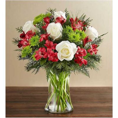 Bring joy to loved ones near and far with our blissful Christmas bouquet. Decked in timeless season colors, it’s a gift sure to fill them with the holiday spirit.
<ul>
 	<li>All-around arrangement with white roses, red Peruvian lilies (alstroemeria) and green athos poms; accented with assorted Christmas greenery</li>
</ul>
<ul>
 	<li>Artistically designed in a clear glass gathering vase</li>
</ul>
<ul>
 	<li>Our florists hand-design each arrangement, so colors, varieties and container may vary due to local availability</li>
 	<li>To ensure lasting beauty, Peruvian lilies may arrive in bud form and will fully bloom over the next few days</li>
</ul>