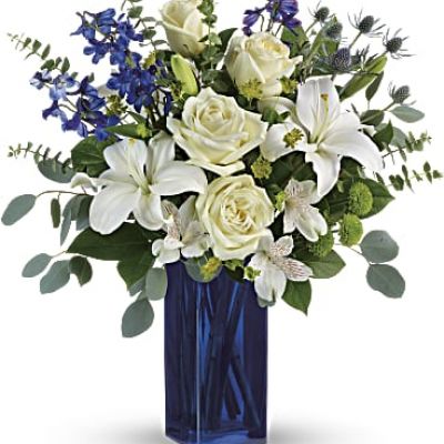 With its glass vase and pure white blooms, this soothing bouquet is a stylish gesture for any special occasion!
This arrangement includes white roses, white asiatic lilies, white alstroemeria, green button spray chrysanthemums, blue eryngium, bupleurum, spiral eucalyptus, silver dollar eucalyptus, and lemon leaf.
<ul>
 	<li>Our florists hand-design each arrangement, so colors, varieties and containers may vary due to local availability</li>
</ul>