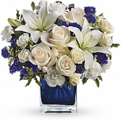 <div class="m-pdp-tabs-description">
<div id="mark-1" class="m-pdp-tabs-marketing-description">Send someone a bit of heaven with this beautiful bouquet. Luxurious crème roses and pure white lilies paint a peaceful picture inside a blue cube.</div>
</div>
Crème roses, white asiatic lilies and white miniature carnations are mixed with bursts of purple statice and green pitta negra. Delivered in a glass cube.
<ul>
 	<li>Our florists hand-design each arrangement, so colors, varieties and container may vary due to local availability</li>
</ul>