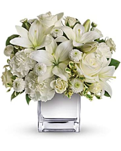 This exquisite all-white bouquet in a dazzling mirrored silver cube may be petite, but it will make a huge impression.
So much beauty for such a merrily modest price tag.
The lovely bouquet includes white roses, white spray roses, white Asiatic lilies, white carnations and white button spray chrysanthemums accented with assorted greenery.
<ul>
 	<li>Our florists hand-design each arrangement, so colors, varieties and containers may vary due to local availability</li>
</ul>