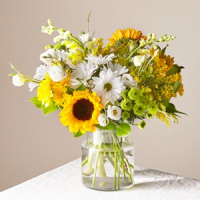 Give a dose of sunshine in bloom. This stunning bouquet is teeming with rays of sunflowers, textured snapdragons and darling daisy poms to deliver the perfect pick-me-up for an occasion or as a treat to yourself.