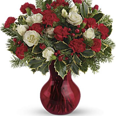 Fill your winter with joy. This sweet arrangement features white spray roses and red miniature carnations presented in glass vase.
White spray roses and red miniature carnations are accented with tips of douglas fir, holly and red berry spray.
<ul>
 	<li>Our florists hand-design each arrangement, so colors, varieties and containers may vary due to local availability</li>
</ul>