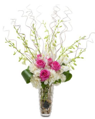Standout with Wisps of Wonder, a stunning display of hot pink roses, white hydrangea and orchids.
<ul>
 	<li>Our florists hand-design each arrangement, so colors, varieties and containers may vary due to local availability</li>
</ul>