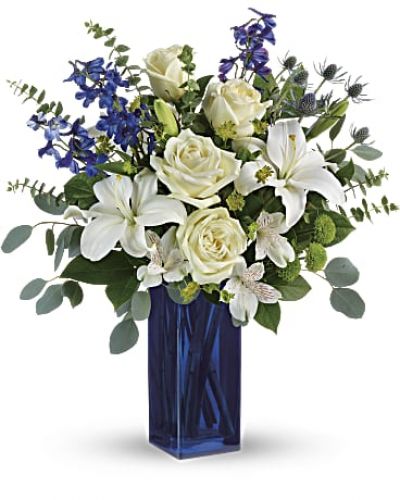 With its glass vase and pure white blooms, this soothing bouquet is a stylish gesture for any special occasion!
This arrangement includes white roses, white asiatic lilies, white alstroemeria, green button spray chrysanthemums, blue eryngium, bupleurum, spiral eucalyptus, silver dollar eucalyptus, and lemon leaf.
<ul>
<li>Our florists hand-design each arrangement, so colors, varieties and containers may vary due to local availability</li>
</ul>