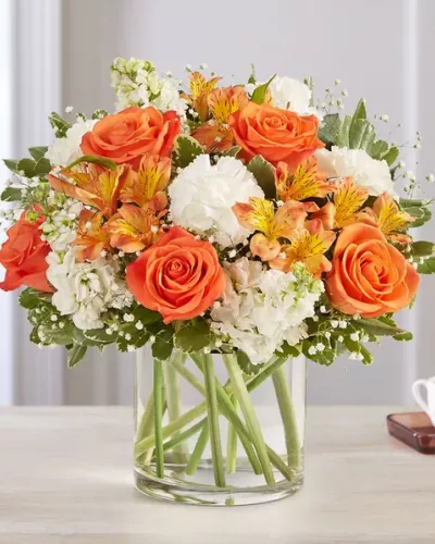 The sweet citrus shades in our charming bouquet bring your sentiments to life. Loosely gathered inside a clear cylinder vase, the mix of vibrant orange and creamy white blooms makes special milestones and everyday moments even more memorable.
<ul>
 	<li>Our florists hand-design each arrangement, so colors, varieties and container may vary due to local availability</li>
</ul>