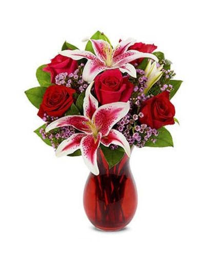 Celebrate your favorite Love Story. Make their heart skip a beat with this romantic bouquet of roses, stargazer lilies and waxflower artfully arranged in a glass vase.
<ul>
 	<li>Our florists hand-design each arrangement, so colors, varieties and container may vary due to local availability</li>
</ul>