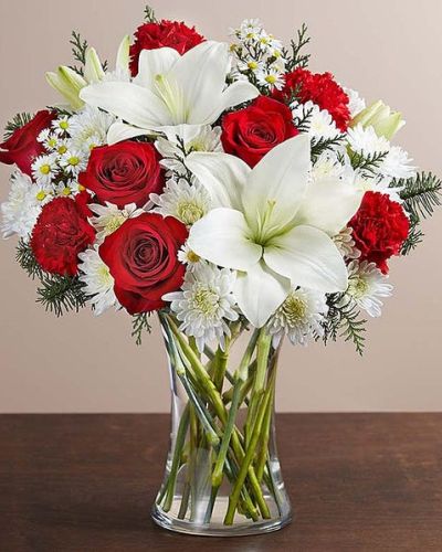 There’s a whole lot of holiday spirit in our charming bouquet. We’ve gathered a mix of blooms in classic Christmas colors, creating a thoughtful gift for the most wonderful time of the year.
<ul>
 	<li>Our florists hand-design each arrangement, so colors, varieties and containers may vary due to local availability</li>
</ul>