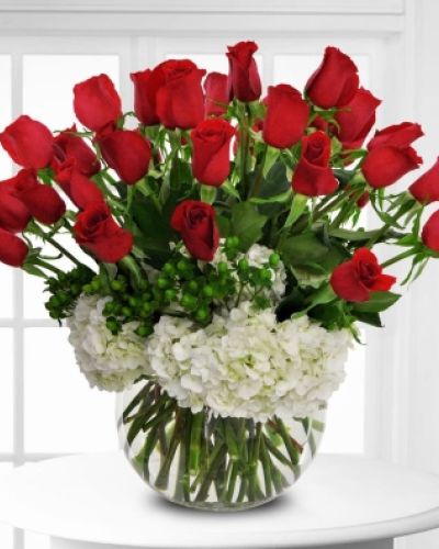 From pure love to pure romance, this beautiful arrangement of red roses and white hydrangeas is set to impress.
<ul>
 	<li>Our florists hand-design each arrangement, so colors, varieties and containers may vary due to local availability</li>
</ul>