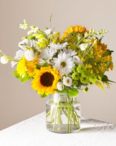 Give a dose of sunshine in bloom. This stunning bouquet is teeming with rays of sunflowers, textured snapdragons and darling daisy poms to deliver the perfect pick-me-up for an occasion or as a treat to yourself.
<ul>
<li>Our florists hand-design each arrangement, so colors, varieties and containers may vary due to local availability</li>
</ul>