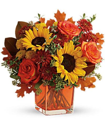 <div id="mark-3" class="m-pdp-tabs-marketing-description">Greet the new season with this heartwarming sunflower and rose bouquet, presented in a cheerful orange cube vase.</div>
<div id="desc-3">
<ul>
 	<li>This bright bouquet includes orange roses, yellow sunflowers, gold cushion spray chrysanthemums, rust cushion spray chrysanthemums, seeded eucalyptus, oregonia, and magnolia leaves.</li>
 	<li>Our florists hand-design each arrangement, so colors, varieties and containers may vary due to local availability</li>
</ul>
</div>