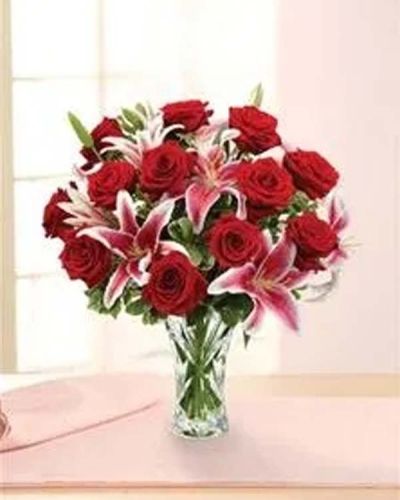 Conjure classic romance with this blossoming bouquet of long-stem red roses, lilies and pittosporum beautifully hand-arranged.
<ul>
 	<li>Our florists hand-design each arrangement, so colors, varieties and containers may vary due to local availability</li>
</ul>