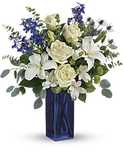 With its glass vase and pure white blooms, this soothing bouquet is a stylish gesture for any special occasion!
This arrangement includes white roses, white asiatic lilies, white alstroemeria, green button spray chrysanthemums, blue eryngium, bupleurum, spiral eucalyptus, silver dollar eucalyptus, and lemon leaf.
<ul>
<li>Our florists hand-design each arrangement, so colors, varieties and containers may vary due to local availability</li>
</ul>