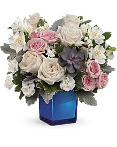 <div id="mark-3" class="m-pdp-tabs-marketing-description">Soft as a whisper, this enchanting bouquet of cream and pink roses looks oh-so-lovely in a colored or clear glass cube that later becomes a comely candleholder.</div>
<div id="desc-3">Crème roses, pink spray roses, white alstroemeria and miniature white carnations are arranged with variegated pittosporum, dusy miller, white sinuata statice and a large, potted green echeveria succulent.
<ul>
<li>Our florists hand-design each arrangement, so colors, varieties and containers may vary due to local availability</li>
</ul>
</div>