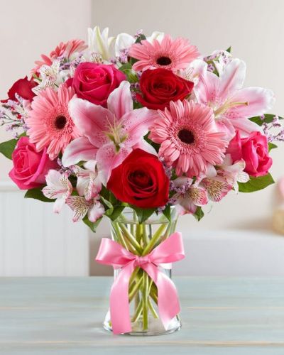 Inspired by the rich beauty of the European countryside, our romantic bouquet reveals all the feelings you have in your heart. Fresh-picked pink & red blooms are on display inside a glass vase finished with ribbon, creating a timeless gift for someone you love.