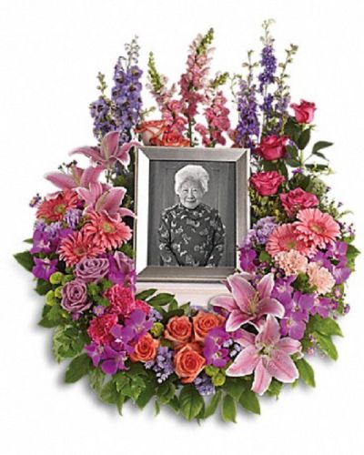 <div class="m-pdp-tabs-description">
<div id="mark-1" class="m-pdp-tabs-marketing-description">Devotion is expressed and beautiful memories cherished with this deep-hued and softly elegant wreath. A lovely reminder of your affection and respect.</div>
</div>
A mix of dramatic flowers such as purple orchids and asters, orange, dark pink and lavender roses, pink and peach carnations, lavender larkspur, green chrysanthemums, and a range of pink blooms including oriental lilies, gerbers, snapdragons and more. Please note: Arrangement does not include picture frame.
<ul>
 	<li>Our florists hand-design each arrangement, so colors, varieties and containers may vary due to local availability</li>
</ul>