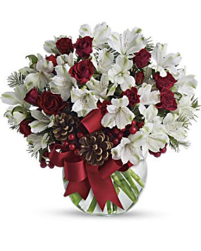 Fresh as new fallen snow. Delicate, snow white flowers are decorated with berries and pinecones for a unique spin on tradition. Presented in a crystal clear bowl tied with red ribbon, this Christmas floral arrangement is exceptionally value priced.
White alstroemeria and Douglas fir are mixed with pinecones and red berries in a clear bowl decorated with red satin ribbon.
<ul>
 	<li>Our florists hand-design each arrangement, so colors, varieties and containers may vary due to local availability</li>
</ul>