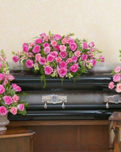 Casket spray, standing spray and urn design in peaceful pink colors.
<ul>
 	<li>Our florists hand-design each arrangement, so colors, varieties and containers may vary due to local availability</li>
</ul>