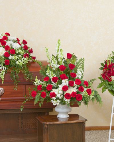 Red and white casket spray, urn and wreath.
<ul>
 	<li>Our florists hand-design each arrangement, so colors, varieties and containers may vary due to local availability</li>
</ul>