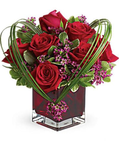 You'll love the Sweet Thoughts bouquet, and you'd like to make a big impression. Send this premium version, and they'll know they've got your heart! With more roses - but the same classic, collectible cube vase in a shade of warmest crimson - this gift will be a surefire hit.
A deluxe mix of red roses and purple waxflower - accented with bear grass and greenery.
<ul>
 	<li>Our florists hand-design each arrangement, so colors, varieties and containers may vary due to local availability</li>
</ul>