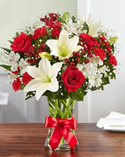 That feeling of bliss, captured in a bouquet. Inspired by the beauty of the European countryside, our best seller brings together radiant roses and lush lilies in a glass vase wrapped in red ribbon. Whatever your reason for reaching out, it’s a gift that delivers on delight.
<ul>
 	<li>Our florists hand-design each arrangement, so colors, varieties and container may vary due to local availability</li>
</ul>
&nbsp;