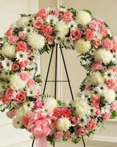 Finding the perfect expression of your care and concern during difficult times requires thoughtful consideration. This standing wreath - crafted from exquisite pink and white flowers such as roses, alstroemeria, and carnations accented by baby's breath, salal, heather and more - beautifully reflects the love and sympathy that is in your heart. Appropriate for family, friends and business associates to send directly to the funeral home.
<ul>
 	<li>Our florists hand-design each arrangement, so colors, varieties and containers may vary due to local availability</li>
</ul>