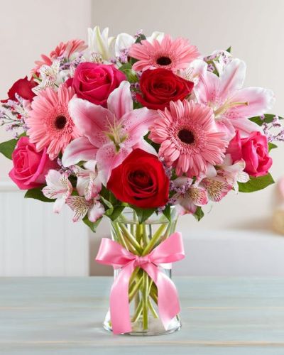 Inspired by the rich beauty of the European countryside, our romantic bouquet reveals all the feelings you have in your heart. Fresh-picked pink & red blooms are on display inside a glass vase finished with ribbon, creating a timeless gift for someone you love.