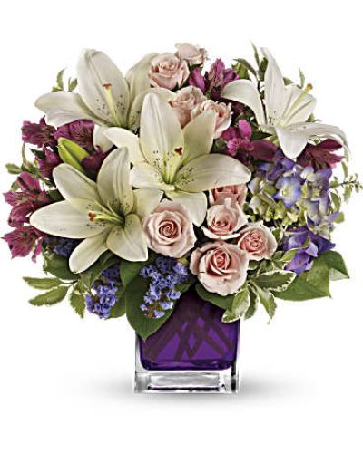 Va-va-bloom! This grand array of purple hydrangea, light pink spray roses and white asiatic lilies is presented in a glass cube.
<ul>
 	<li>Our florists hand-design each arrangement, so colors, varieties and containers may vary due to local availability</li>
</ul>