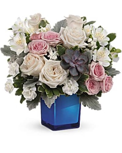 <div id="mark-3" class="m-pdp-tabs-marketing-description">Soft as a whisper, this enchanting bouquet of cream and pink roses looks oh-so-lovely in a colored or clear glass cube that later becomes a comely candleholder.</div>
&nbsp;
<div id="desc-3">Crème roses, pink spray roses, white alstroemeria and miniature white carnations are arranged with variegated pittosporum, dusy miller, white sinuata statice and a large, potted green echeveria succulent.
<ul>
 	<li>Our florists hand-design each arrangement, so colors, varieties and containers may vary due to local availability</li>
</ul>
</div>