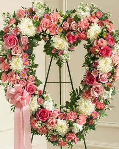 Commemorate them and the special place they will always hold in your heart with this heart-shaped floral arrangement. Crafted by our expert florists using fresh pink and white flowers including roses, stock, carnations and more, it's a beautiful way to send your deepest condolences to family, friends or any special person in your life. Traditionally sent directly to the funeral home by family members or friends and displayed on a stand.
<ul>
 	<li>Our florists hand-design each arrangement, so colors, varieties and containers may vary due to local availability</li>
</ul>