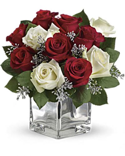 Give Christmas a charmingly contemporary spin with lush red and white roses in a dazzling mirrored silver cube. With a merrily moderate price tag, it makes the perfect gift for all the people on your list – naughty or nice.

The impressive bouquet includes red roses and white roses accented with assorted greenery.
<ul>
 	<li>Our florists hand-design each arrangement, so colors, varieties and containers may vary due to local availability</li>
</ul>