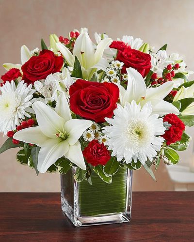 The color most related the heart, let red serve as a reminder that you're thinking of them. Our arrangement of timeless red roses, carnations, and white lilies, expertly gathered together in a clear vase, it is an exquisite gesture of sentiment and caring.
<ul>
 	<li>Our florists hand-design each arrangement, so colors, varieties and containers may vary due to local availability</li>
</ul>
