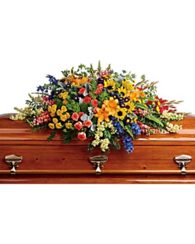 <div id="mark-1" class="m-pdp-tabs-marketing-description">Honor a bright, beautiful life with this colorful burst of hydrangea, roses, lilies and sunflowers that will add a rainbow of hope to the service.</div>
<div id="desc-1">
<ul>
 	<li>Green hydrangea, orange roses, yellow spray roses, orange asiatic lilies, red gladioli, large yellow sunflowers, blue delphinium, orange snapdragons, light yellow stock, purple matsumoto asters, and yellow button spray chrysanthemums are accented with green trick dianthus, blue eryngium, bupleurum, dusty miller and greenery.</li>
 	<li>Our florists hand-design each arrangement, so colors, varieties and containers may vary due to local availability</li>
</ul>
</div>