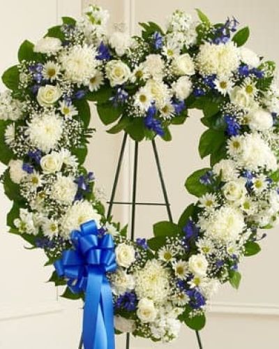 Let their special memories live on forever while expressing your deepest sympathy. This striking, heart-shaped tribute is crafted by our expert florists from fresh, beautiful blue and white blooms to help you offer your comfort and support during a difficult time. Traditionally sent directly to the funeral home by family members or friends and displayed on a stand.
<ul>
 	<li>Our florists hand-design each arrangement, so colors, varieties and containers may vary due to local availability</li>
</ul>