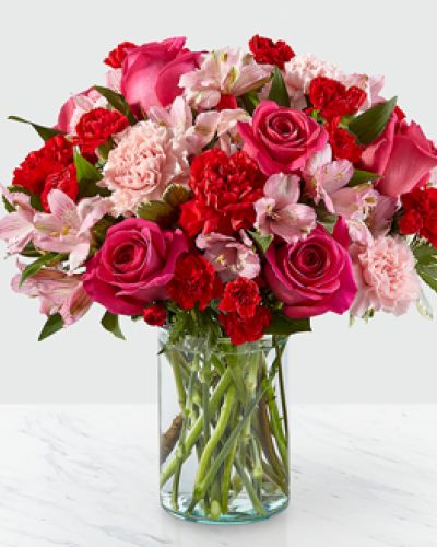 Handcrafted and inspired by the gorgeous hues of the season, the You’re Precious Bouquet is full of sweet sentiment for your favorite person. Hot pink roses, red carnations, pink alstroemeria, and pale pink carnations come together in a clear glass vase to make any room feel beautiful and light. From special birthdays to simply just because, this arrangement is a stunning gift to give your loved ones for every occasion.
<ul>
 	<li>Our florists hand-design each arrangement, so colors, varieties and containers may vary due to local availability</li>
</ul>