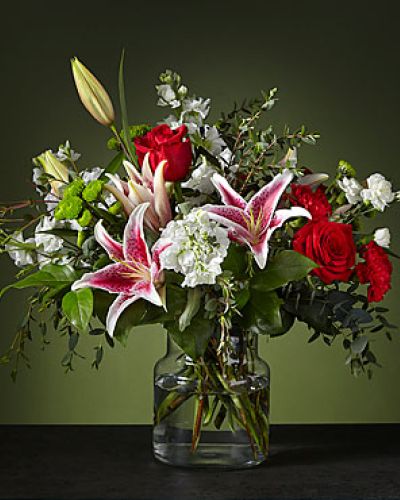 Inspired by the crisp colors of a candy cane, our Peppermint Swirl Bouquet is a fun and festive holiday delight. The starfighter lily's white exterior will bloom with bright color on the inside, complementing the classic ruby carnations.
<ul>
 	<li>Our florists hand-design each arrangement, so colors, varieties and containers may vary due to local availability</li>
</ul>