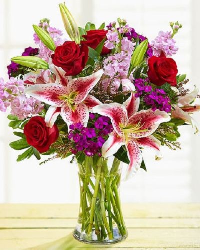 Enjoy this exquisite combination of red and purple bloom guaranteed to make your recipient equally dazzled with the unparalleled beauty of this arrangement. Whether it's for a special occasion or just because, it's a gift that you'll be glad you sent.
<ul>
 	<li>Our florists hand-design each arrangement, so colors, varieties and containers may vary due to local availability</li>
</ul>