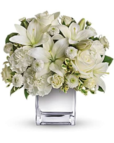 This exquisite all-white bouquet in a dazzling mirrored silver cube may be petite, but it will make a huge impression.
So much beauty for such a merrily modest price tag.
The lovely bouquet includes white roses, white spray roses, white Asiatic lilies, white carnations and white button spray chrysanthemums accented with assorted greenery.
<ul>
 	<li>Our florists hand-design each arrangement, so colors, varieties and containers may vary due to local availability</li>
</ul>
